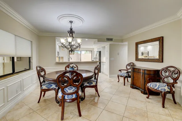 a view of a dining room with furniture and chandelier