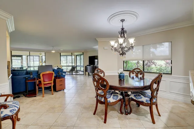 a view of a dining room with furniture and chandelier
