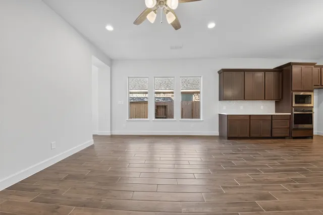 a view of a kitchen with a sink and a refrigerator