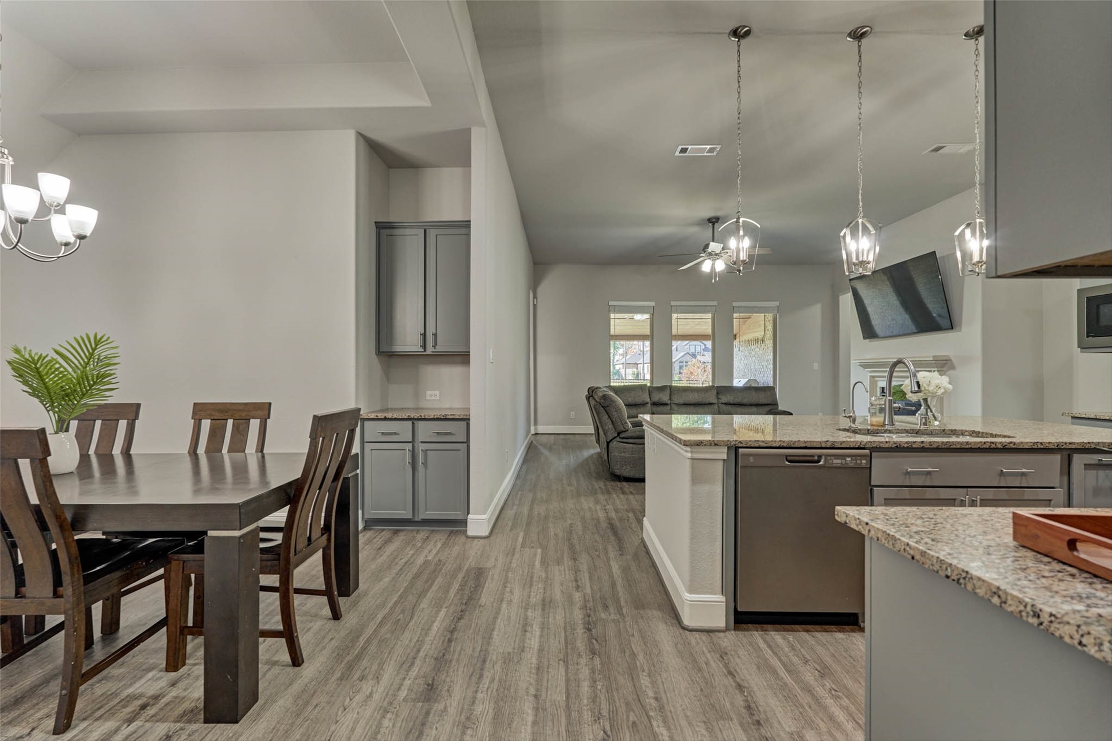 10660 Red Tail Place Conroe, TX 77385 - Photo 12 of 50 a kitchen with stainless steel appliances granite countertop a kitchen island a stove a table and chairs in it