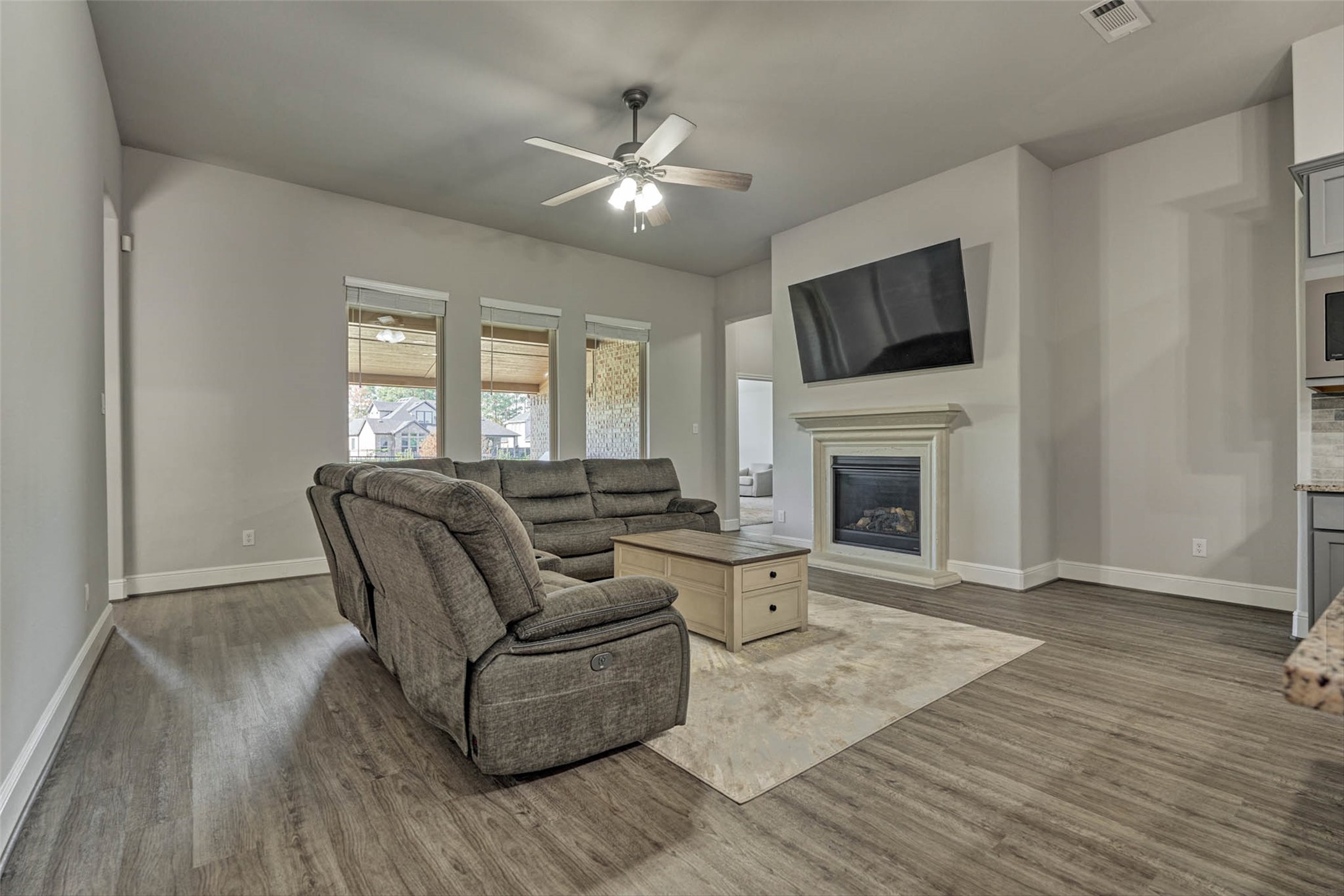 10660 Red Tail Place Conroe, TX 77385 - Photo 17 of 50 a living room with furniture a fireplace and a flat screen tv