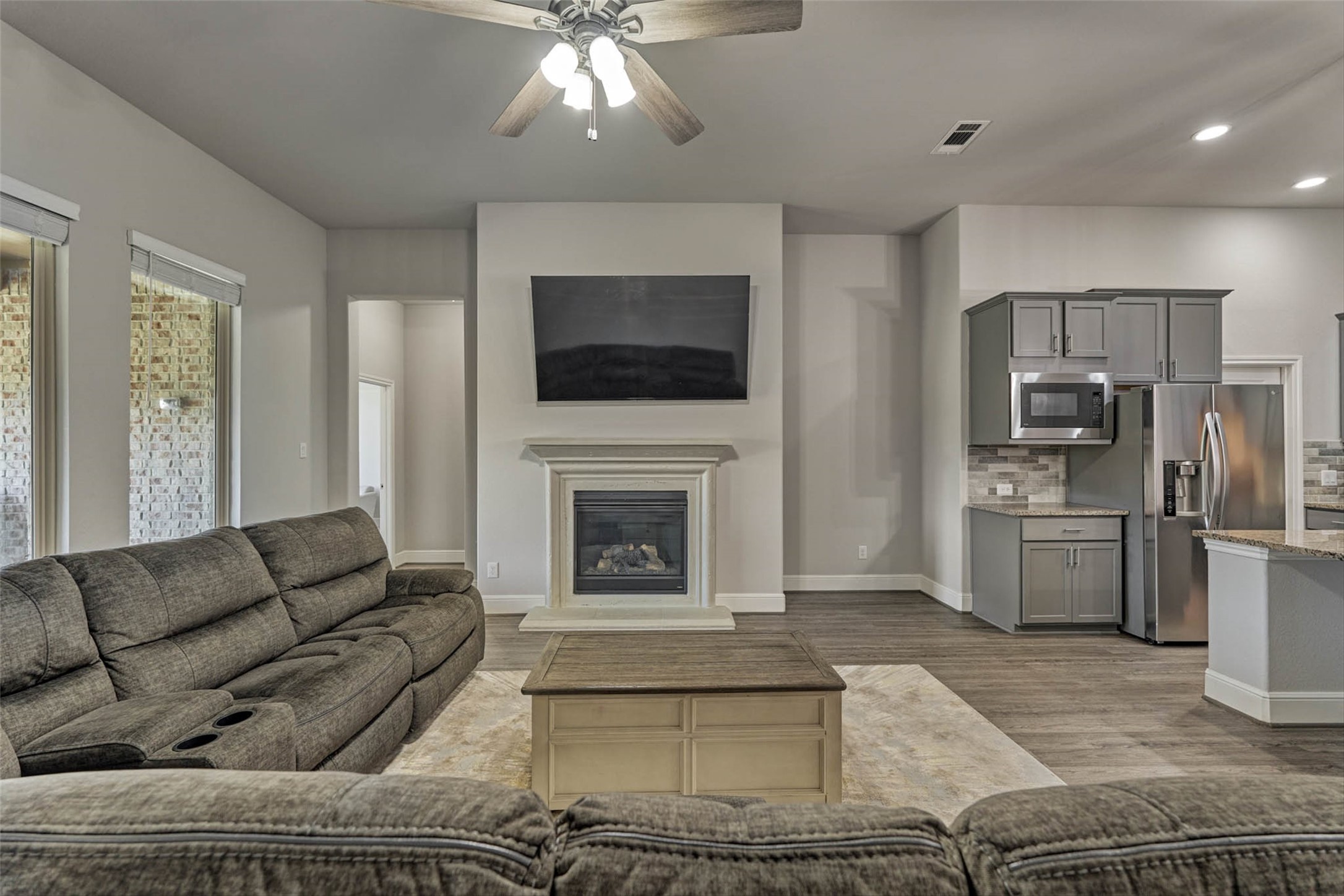 10660 Red Tail Place Conroe, TX 77385 - Photo 18 of 50 a living room with furniture a fireplace and a flat screen tv