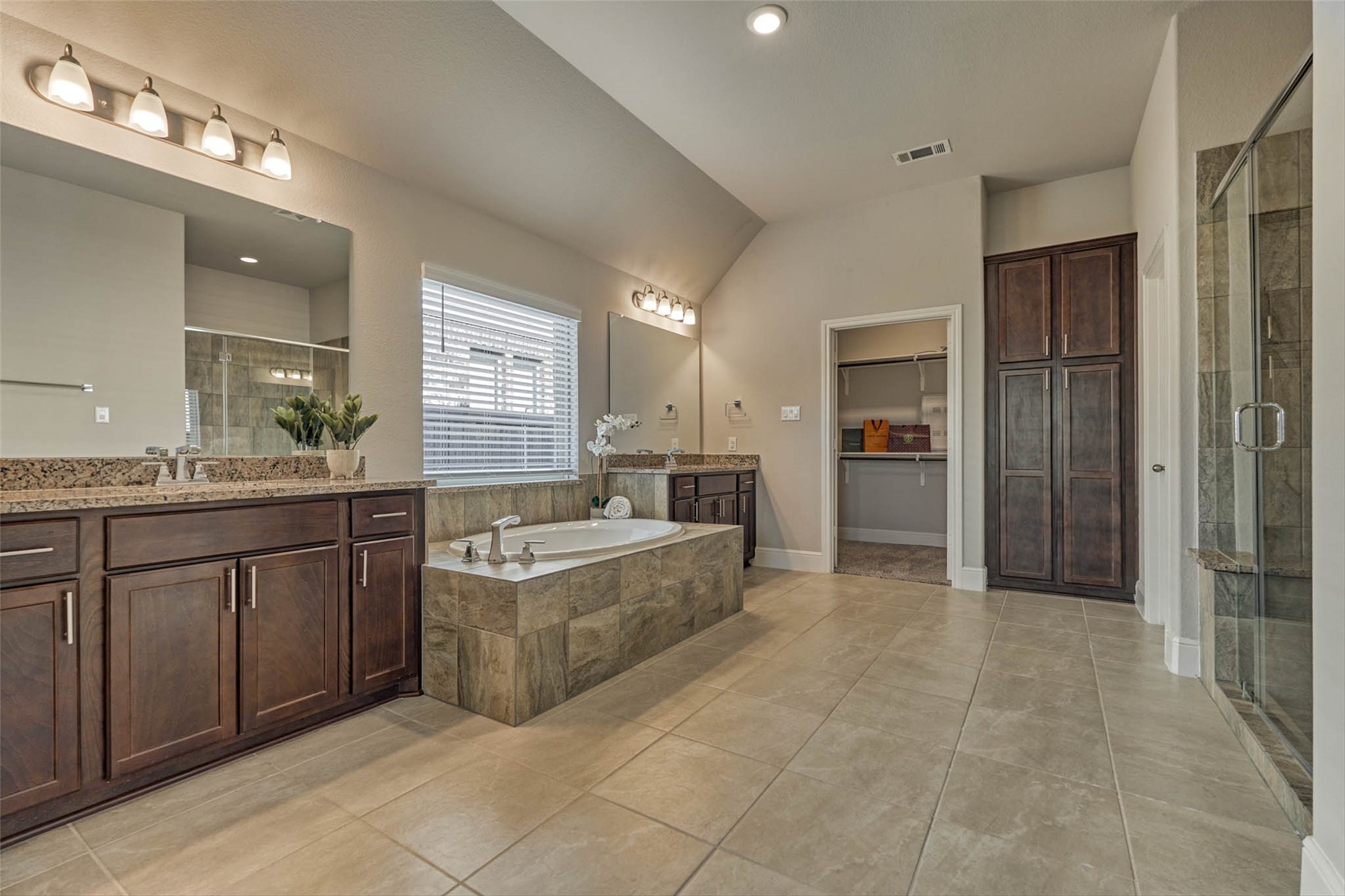10660 Red Tail Place Conroe, TX 77385 - Photo 21 of 50 a large bathroom with a granite countertop double vanity sink a mirror and a shower
