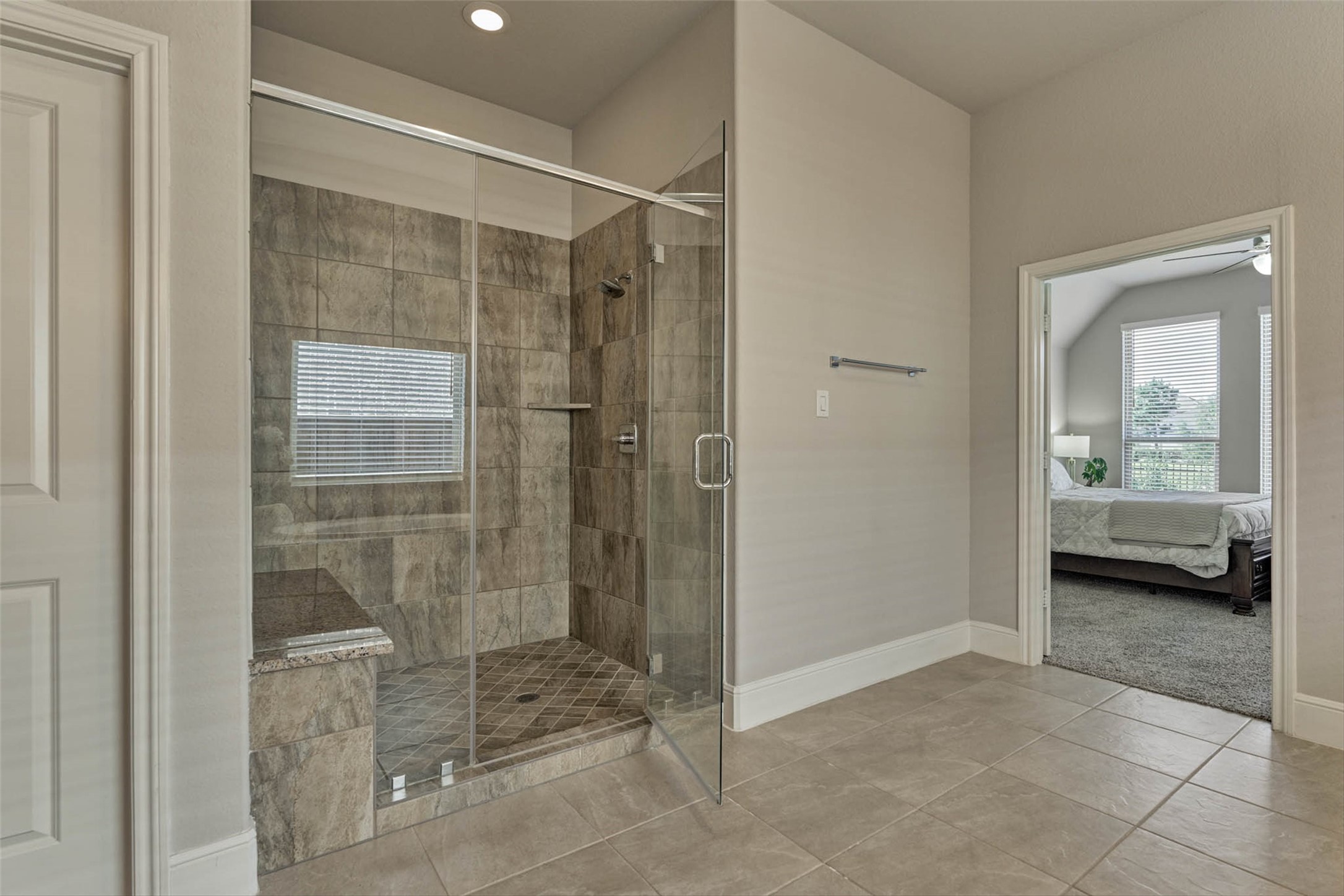 10660 Red Tail Place Conroe, TX 77385 - Photo 23 of 50 a bathroom with a glass shower door