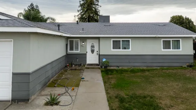 a front view of a house with garden