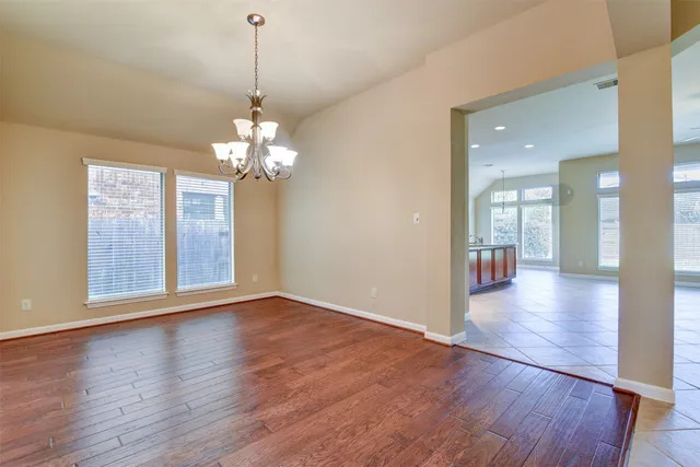 a view of a room with wooden floor and large windows