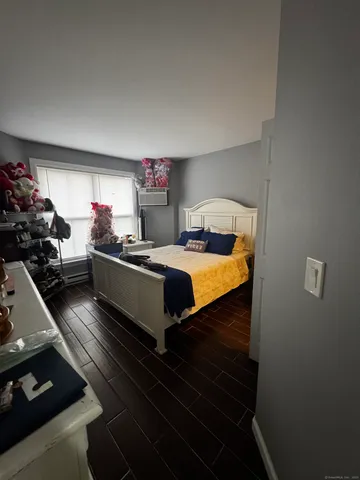 a bedroom with bed and a window