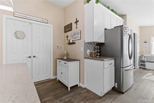 a kitchen with a refrigerator and a sink