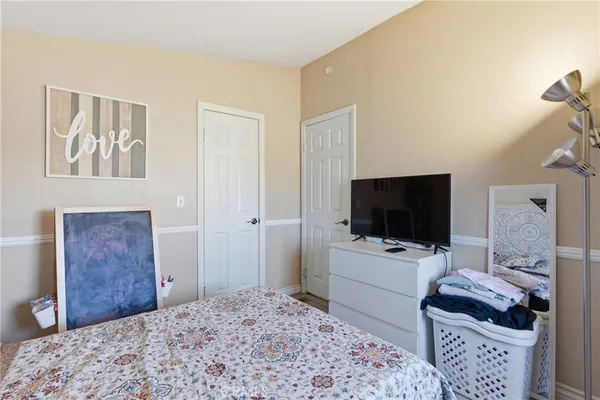 a bedroom with a bed and flat screen tv