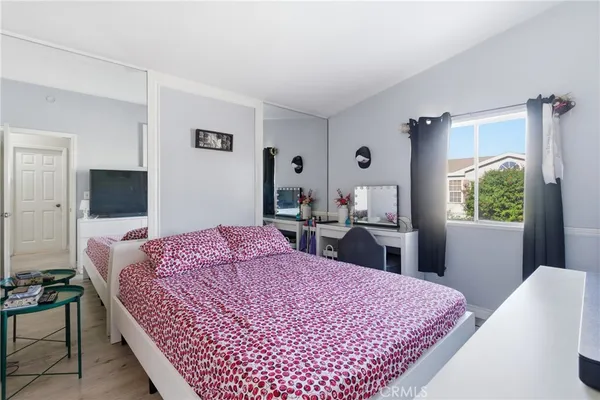 a bed room with a bed and a television