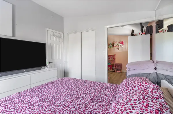 a bedroom with a bed and a flat screen tv