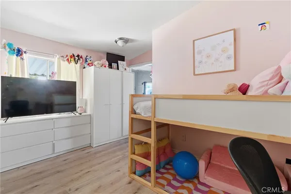 a bedroom with furniture and wooden floor
