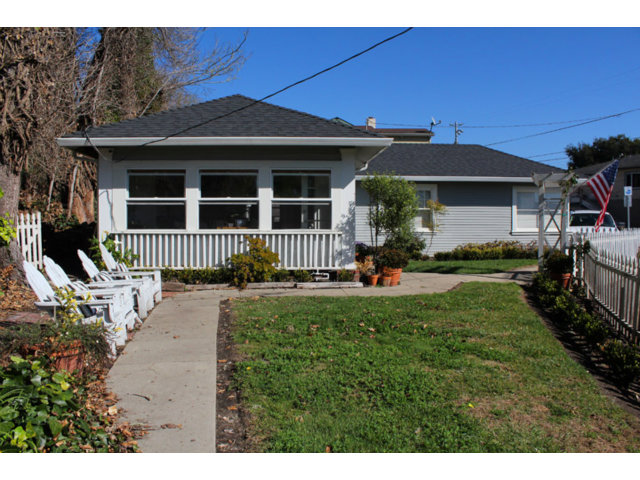 a front view of a house with a garden