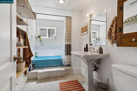 a bathroom with a sink a toilet and a bathtub
