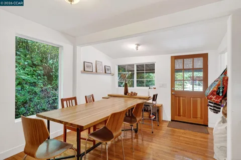 a view of a dining room with furniture window and wooden floor