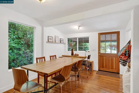 a workspace with wooden floor and a window