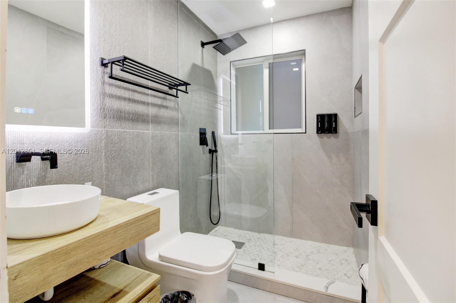 360 Northeast 116th Street Miami, FL 33161 - Photo 12 of 29 a bathroom with a sink toilet and shower