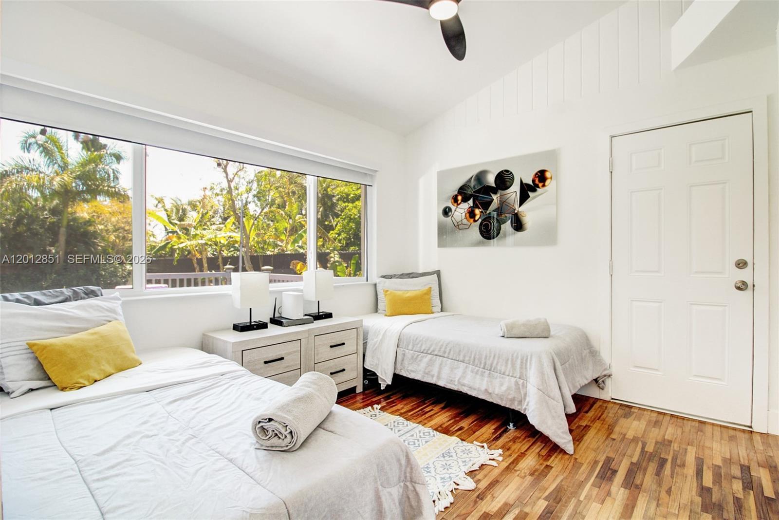 360 Northeast 116th Street Miami, FL 33161 - Photo 15 of 29 a bedroom with a bed and a large window