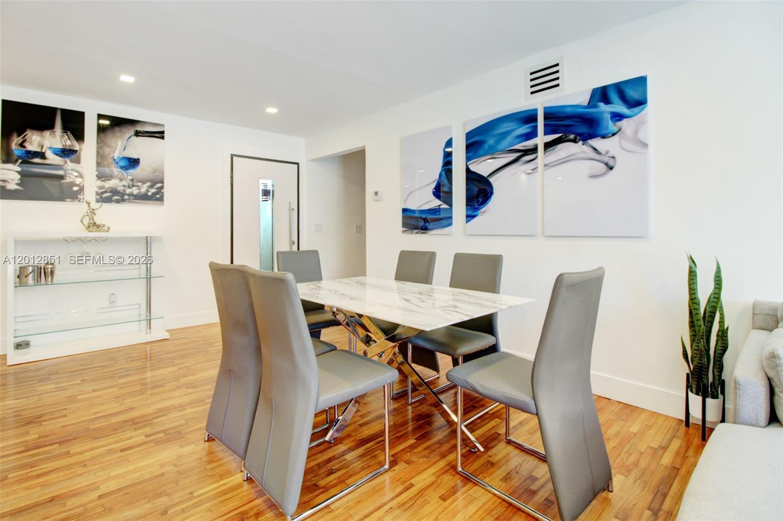 360 Northeast 116th Street Miami, FL 33161 - Photo 17 of 29 a view of a dining room with furniture and wooden floor