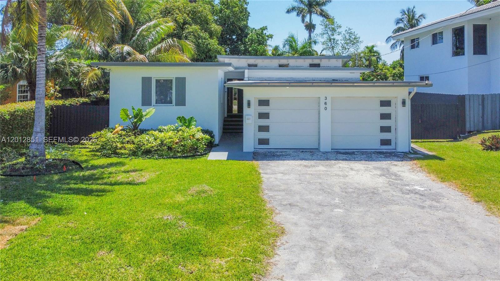 360 Northeast 116th Street Miami, FL 33161 - Photo 25 of 29 a view of a house with a yard and potted plants