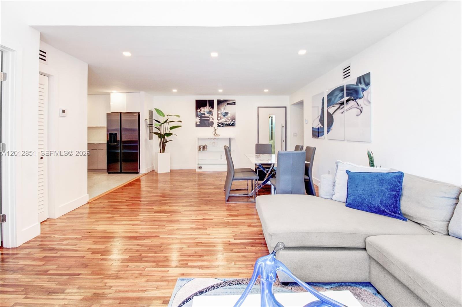 360 Northeast 116th Street Miami, FL 33161 - Photo 3 of 29 a living room with furniture and kitchen view
