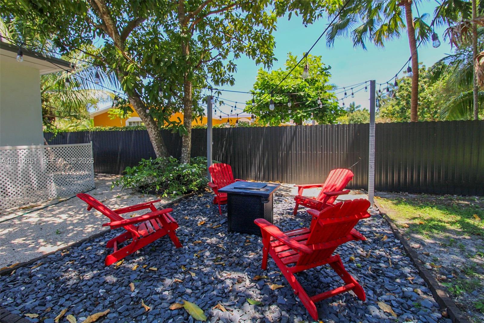 360 Northeast 116th Street Miami, FL 33161 - Photo 7 of 29 a bench is sitting in the middle of a backyard