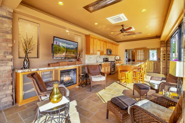 a living room with couches a flat tv dining table and chairs with outer view