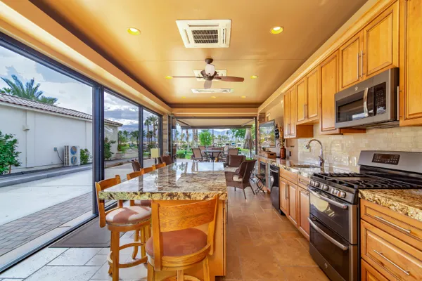 a kitchen with stainless steel appliances granite countertop a refrigerator a sink and dishwasher