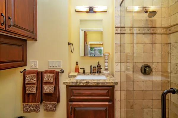 a kitchen with granite countertop sink stove and cabinets
