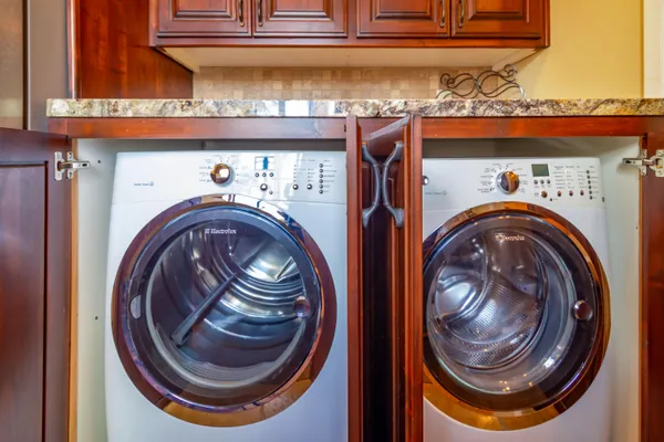 a view of swimming pool with lawn chairs and a yard