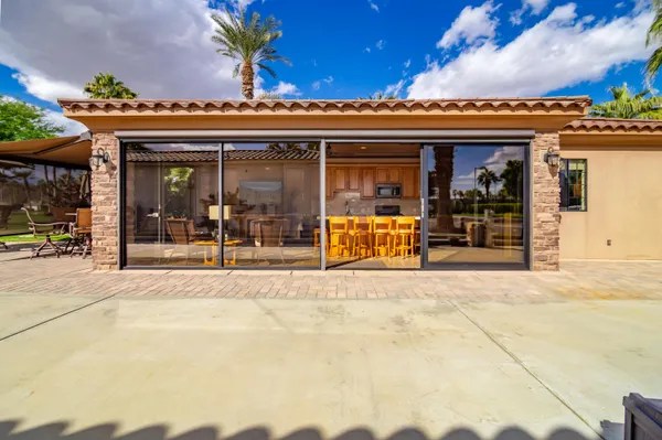a view of a house with swimming pool and sitting area