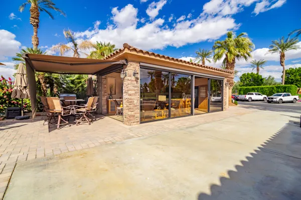 a view of a patio with table and chairs potted plants