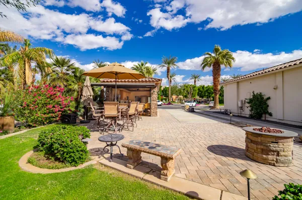 a view of a chairs and table in backyard