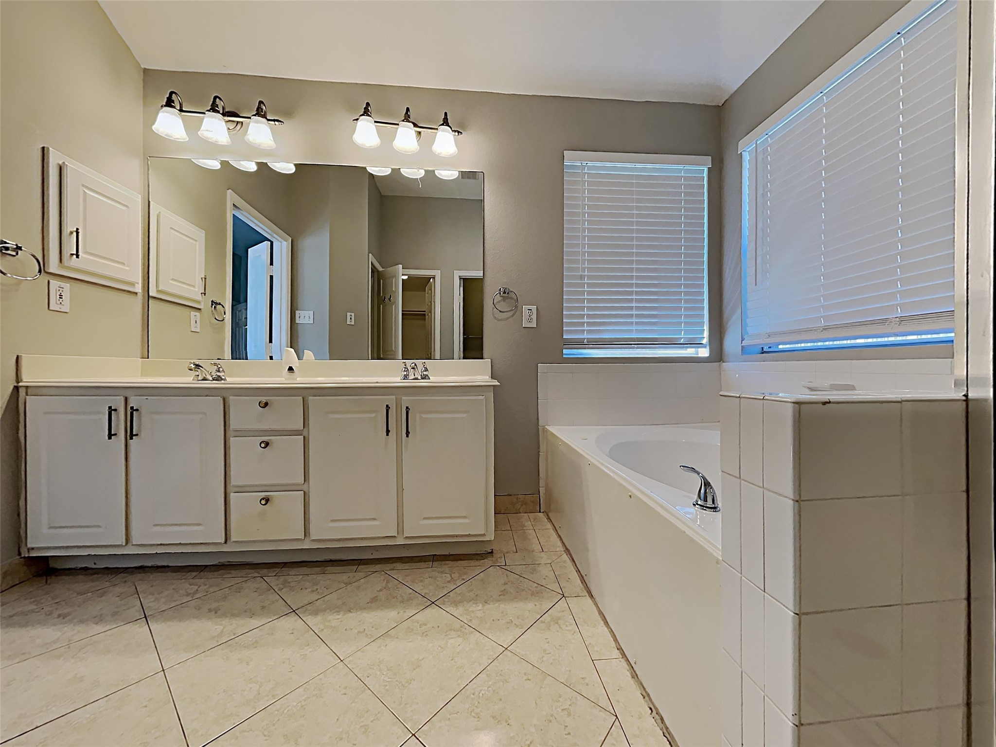 85 Summer Lark Place Spring, TX 77382 - Photo 20 of 20 a bathroom with a sink a vanity a mirror and bathtub