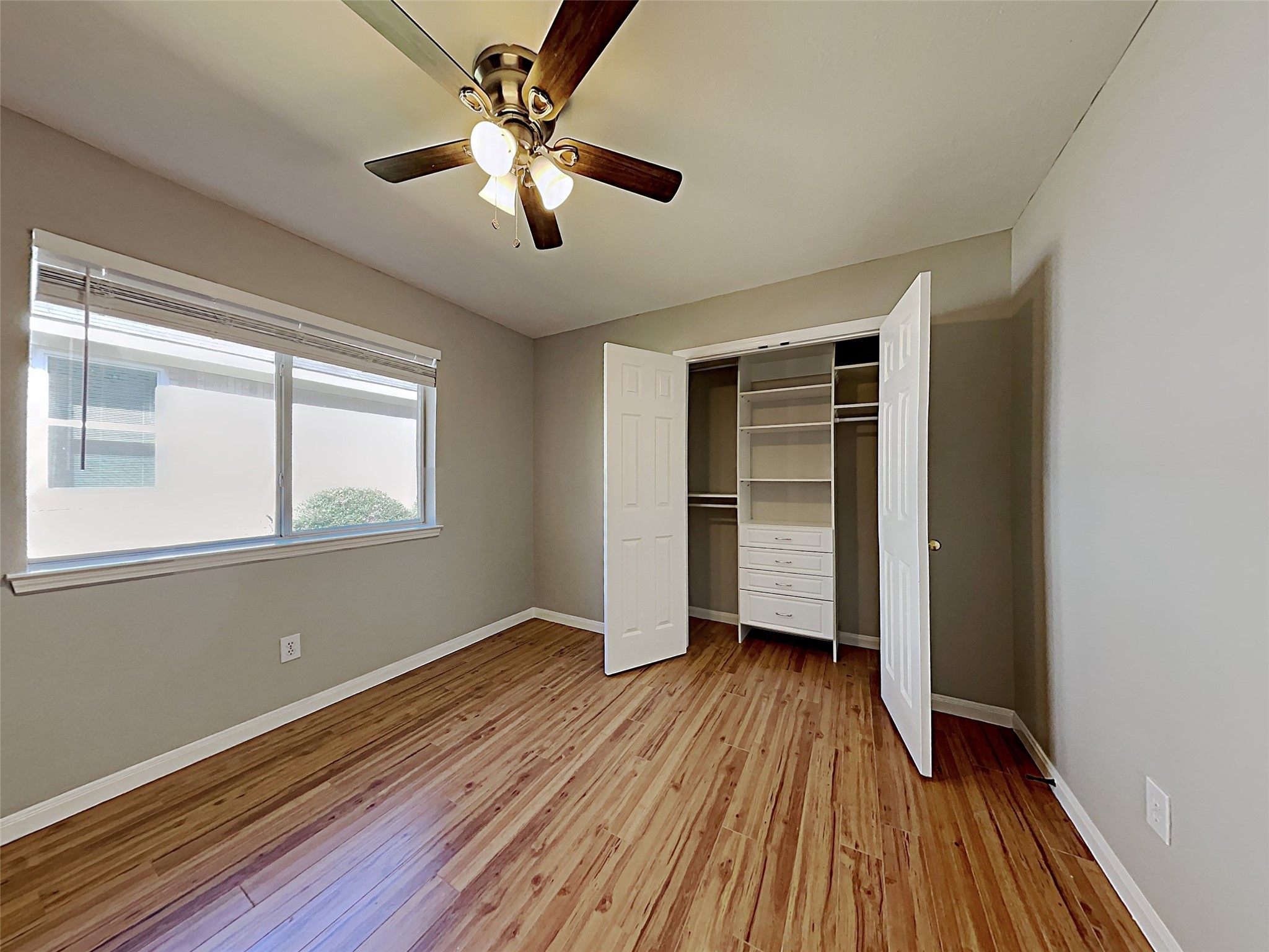 85 Summer Lark Place Spring, TX 77382 - Photo 9 of 20 a view of empty room with wooden floor and fan