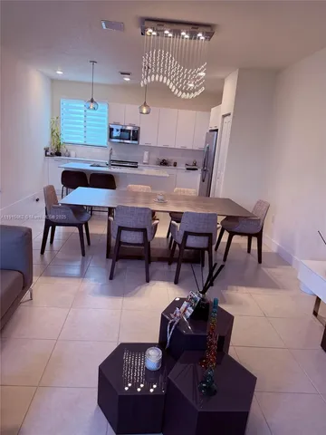 a room with table chairs and wooden floor