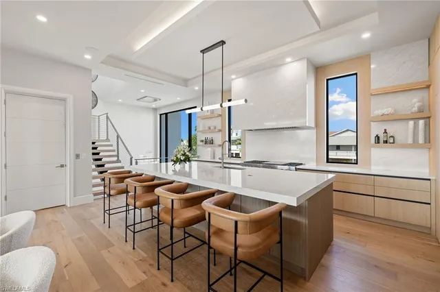 a kitchen with a table chairs and a sink