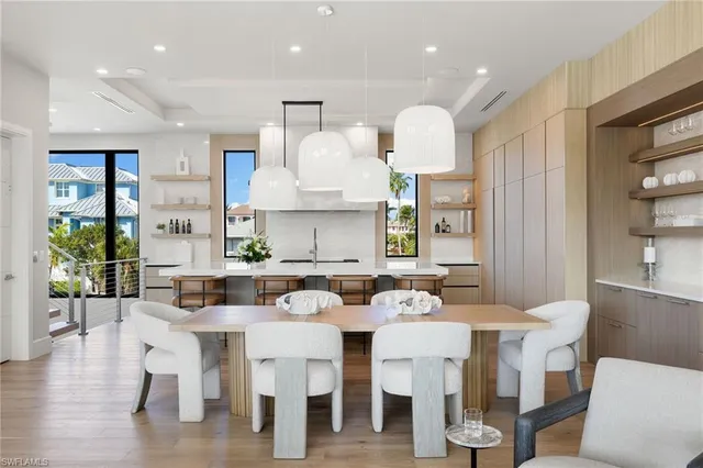 a large kitchen with a table and chairs