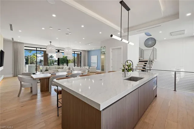 a large kitchen with kitchen island a sink counter space dining table and chairs