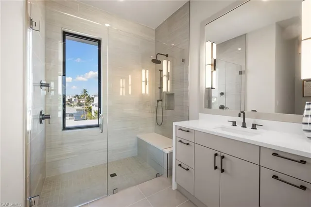 a bathroom with a shower sink and mirror