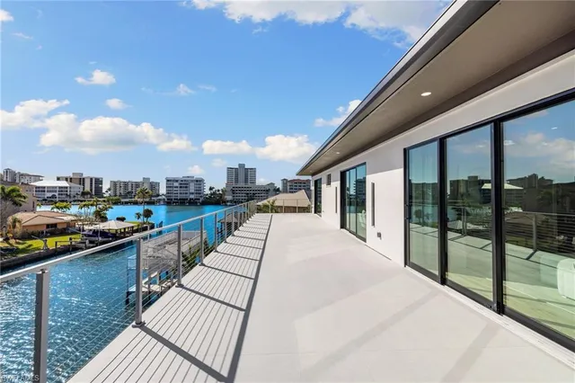 a swimming pool with outdoor seating and yard
