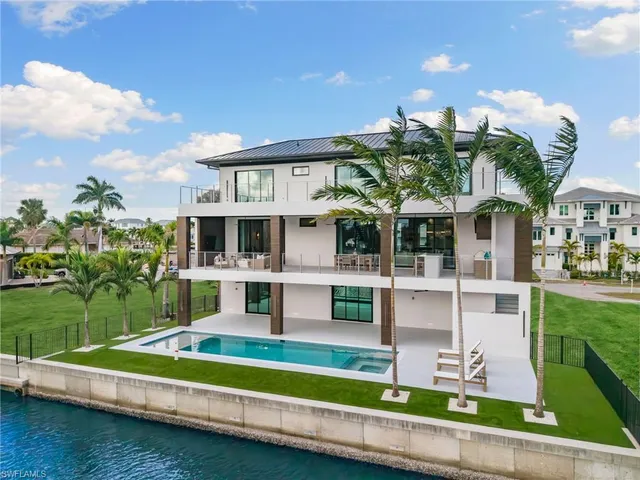a view of house with swimming pool and yard