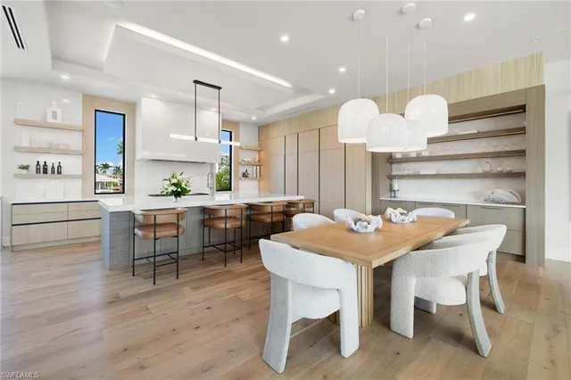 a kitchen with a table chairs a sink dishwasher a dining table and chairs