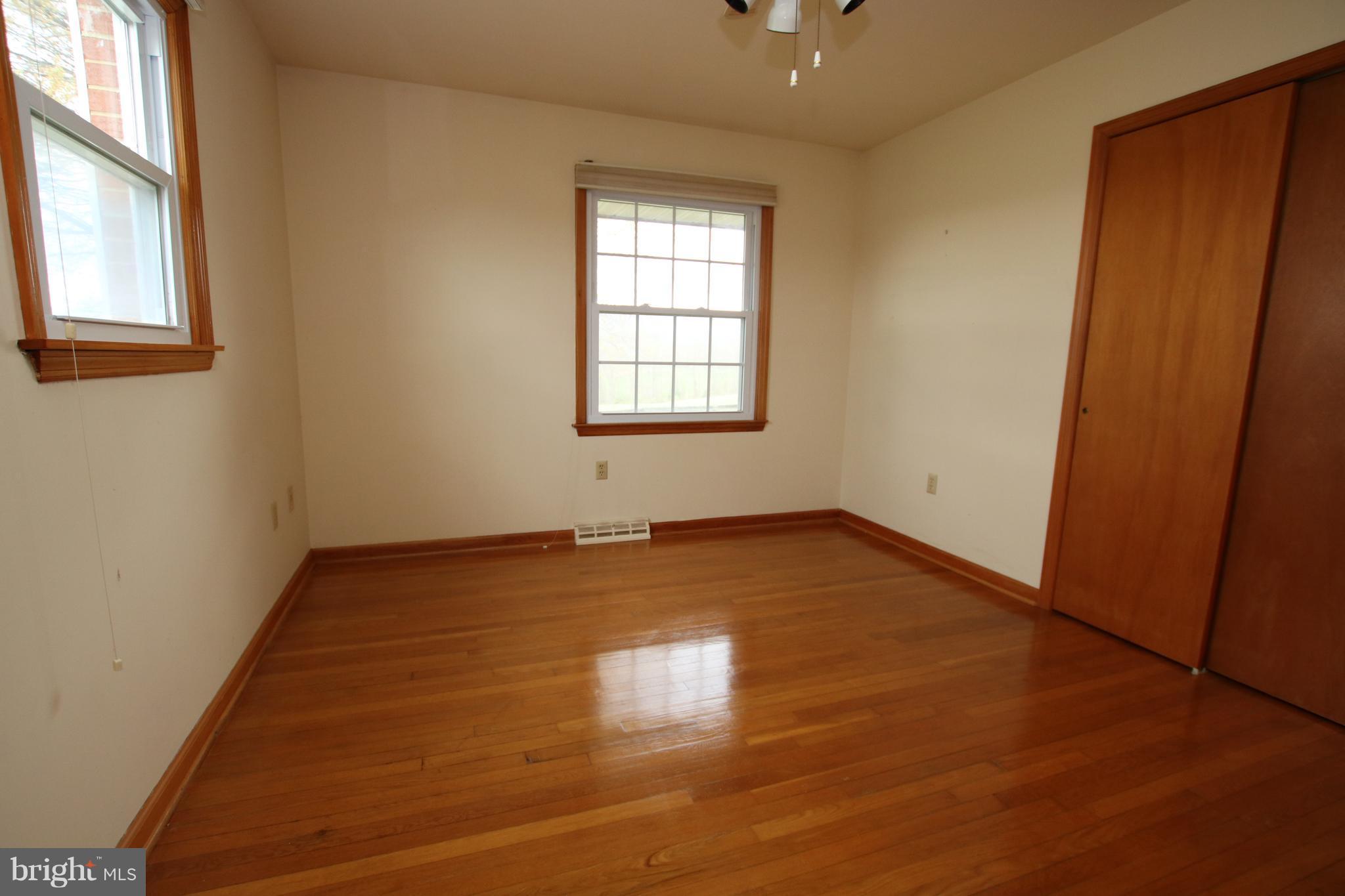 378 Hunters Road Washington, VA 22747 - Photo 14 of 30 an empty room with wooden floor and windows