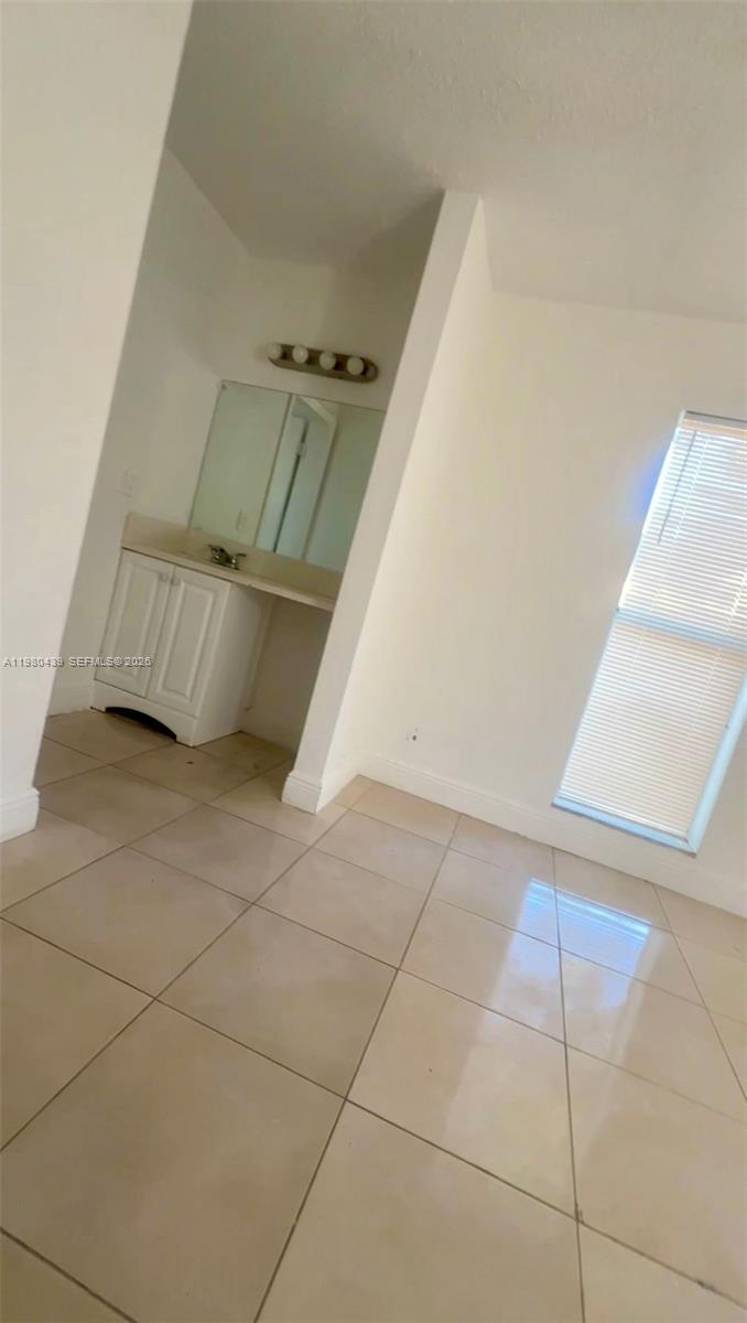 4435 Treehouse Lane, Unit H Tamarac, FL 33319 - Photo 13 of 18 a view of an empty room and window