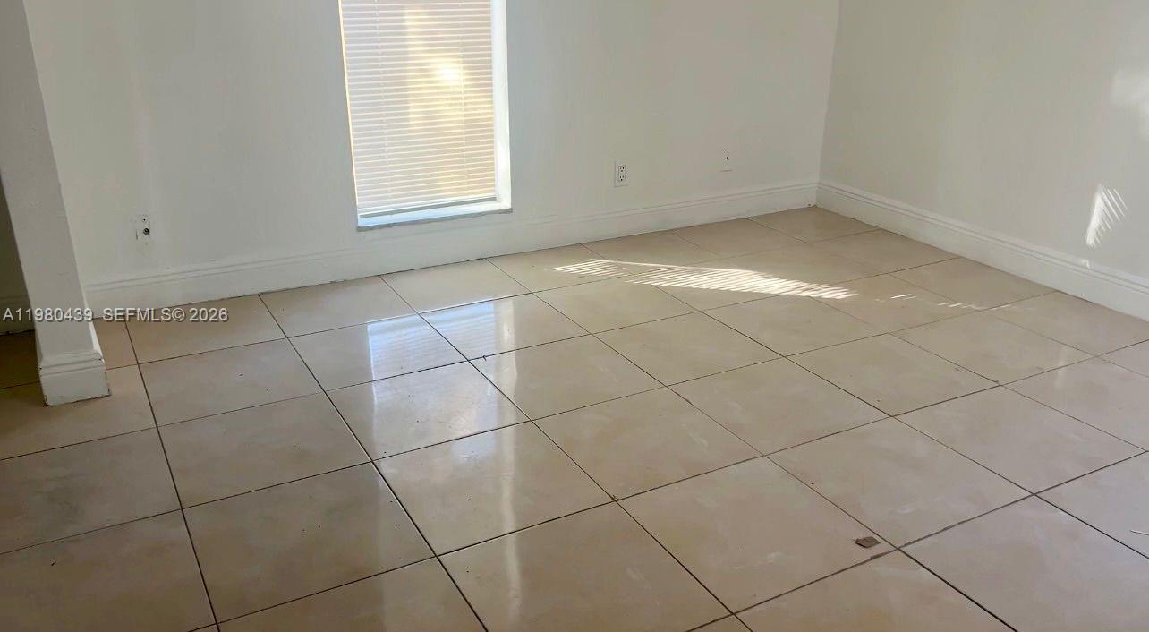4435 Treehouse Lane, Unit H Tamarac, FL 33319 - Photo 14 of 18 a view of a room that has a window in it