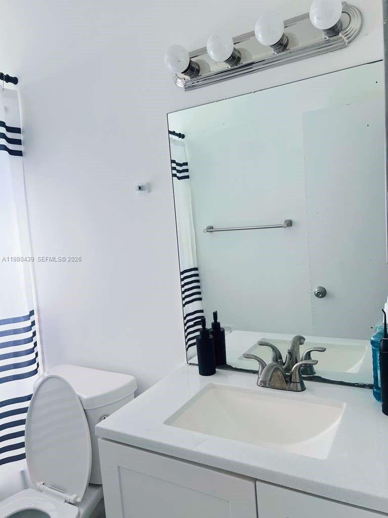 4435 Treehouse Lane, Unit H Tamarac, FL 33319 - Photo 16 of 18 a bathroom with a sink and a toilet