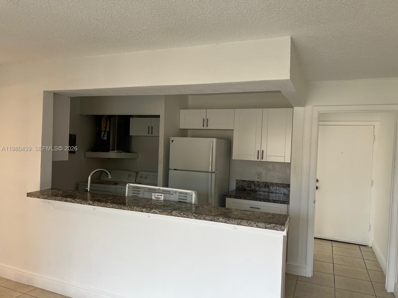 4435 Treehouse Lane, Unit H Tamarac, FL 33319 - Photo 2 of 18 a bathroom with a sink and a mirror