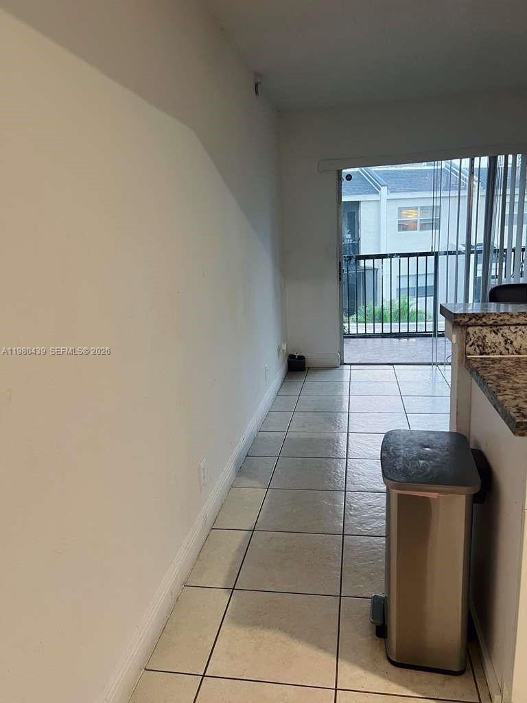 4435 Treehouse Lane, Unit H Tamarac, FL 33319 - Photo 6 of 18 a hallway with a washer and dryer