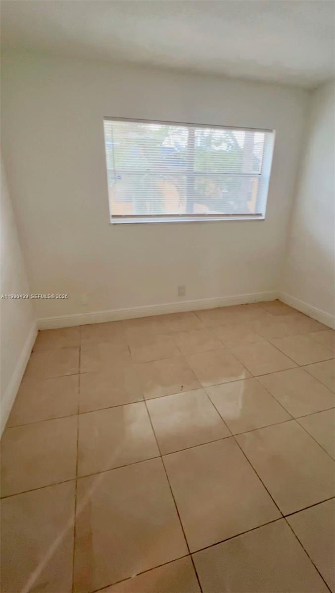 4435 Treehouse Lane, Unit H Tamarac, FL 33319 - Photo 10 of 18 a view of an empty room with a window